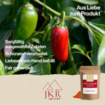 Rote und grüne Jalapenos an einem Zweig hängend. Text: Sorgfältig ausgewählte Zutaten, Schonend verarbeitet, Liebevoll von Hand befüllt, Fair gehandelt.