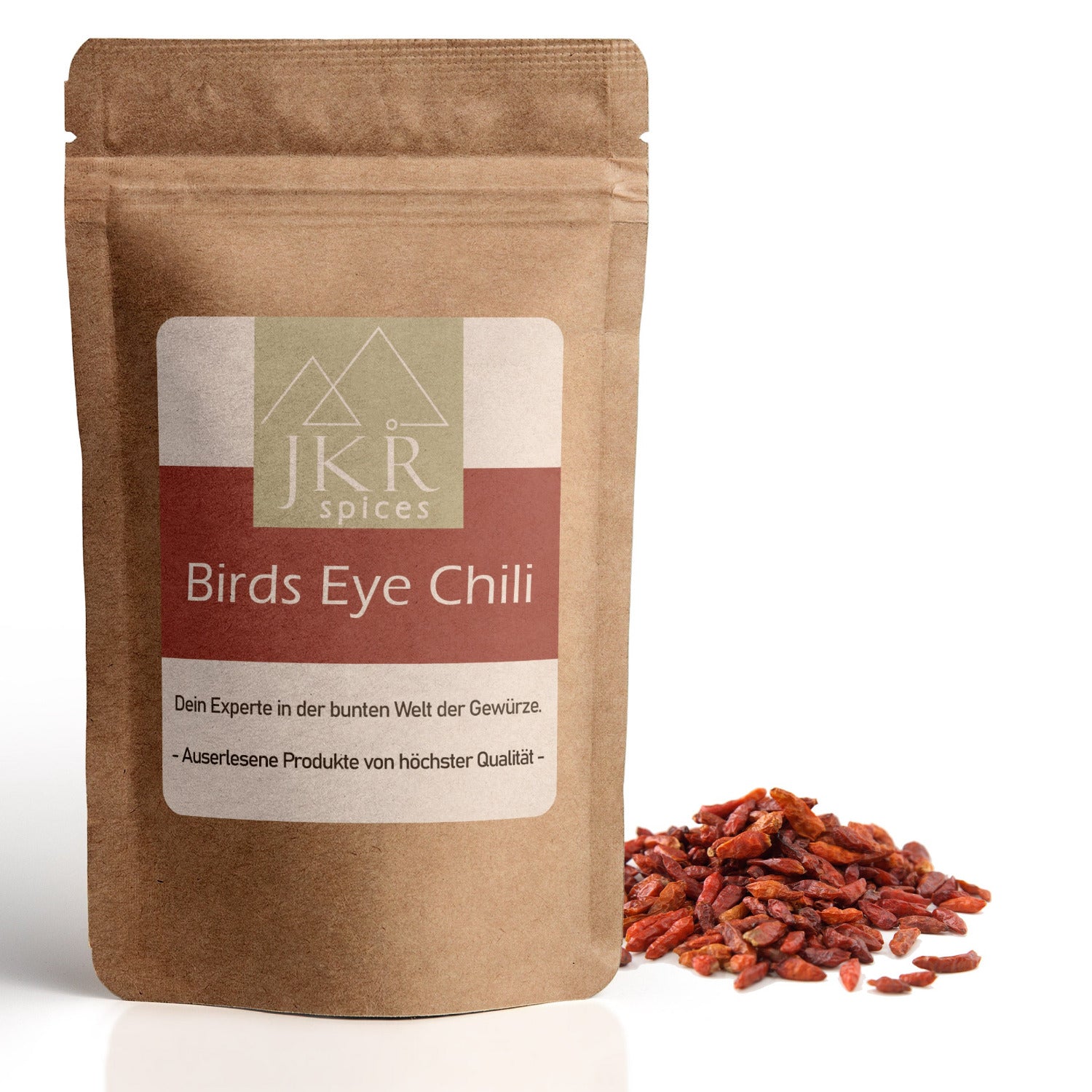 JKR Spices Birds Eye Chili im Doypack – ganze getrocknete Bird’s Eye Chilis in hochwertiger Qualität, naturbelassen und schonend verarbeitet, rote Chilischoten neben dem Produktbeutel