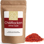 Chili Flocken im braunen JKR Doypack mit sichtbaren roten Chiliflocken daneben – leicht scharfes Gewürz in hochwertiger Verpackung