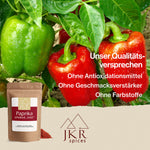 Grüne und rote Paprikaschoten am Strauch hängend. Text: Unser Qualitätsversprechen: Ohne Antioxidationsmittel/Ohne Geschmacksverstärker/Ohne Farbstoffe