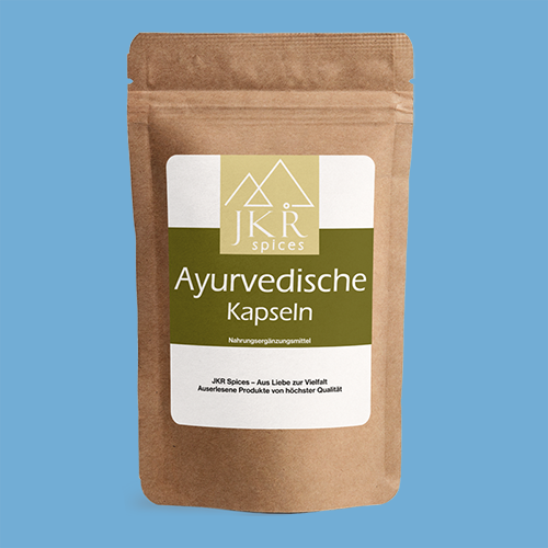 JKR Spices Ayurvedische Kapseln im braunen Doypack mit Etikett auf blauem Hintergrund Vorderseite des Produkts
