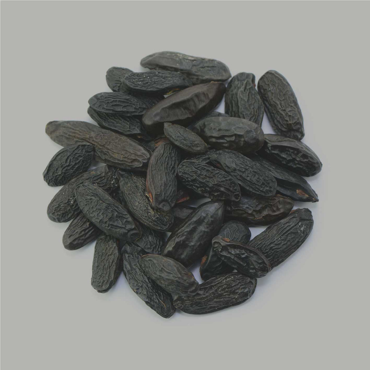 Tonkabohnen Nahaufnahme, ganze schwarze Tonkabohnen als Rohware auf hellem Hintergrund